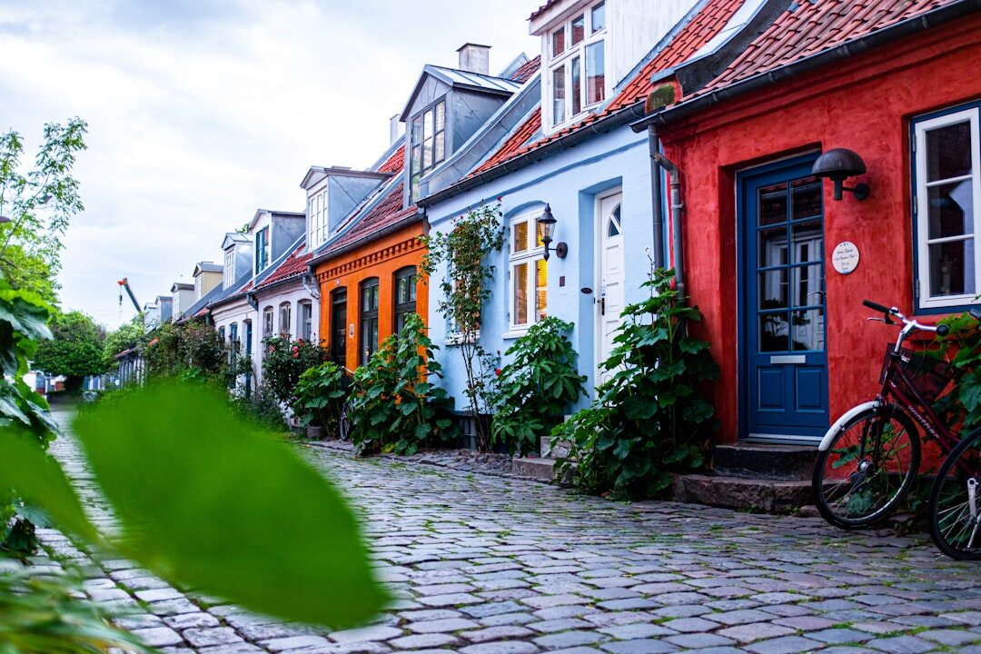 Narrow cobblestone street in a small Danish coastal town with colourful houses