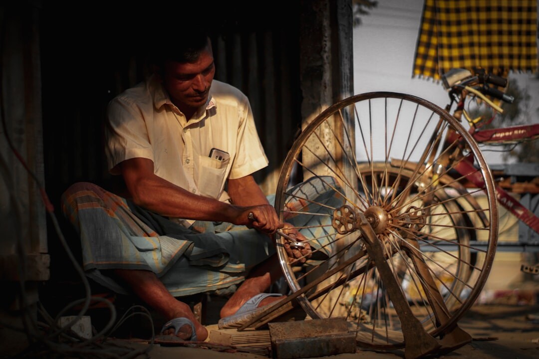 man repairing bicycle