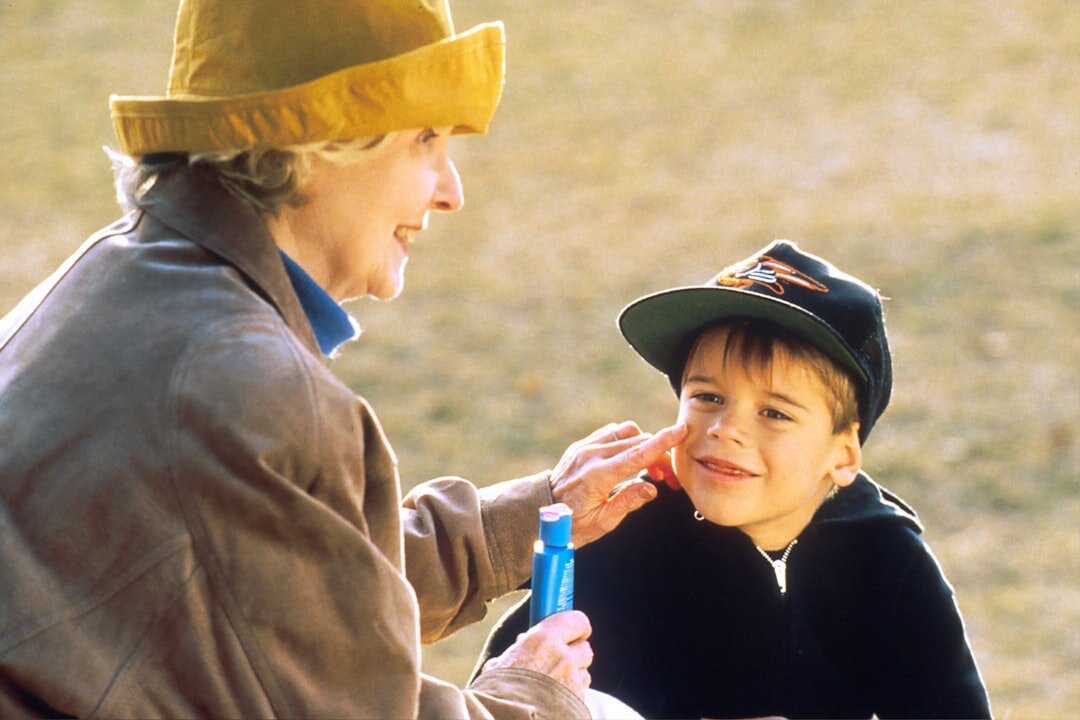 elderly person helping child