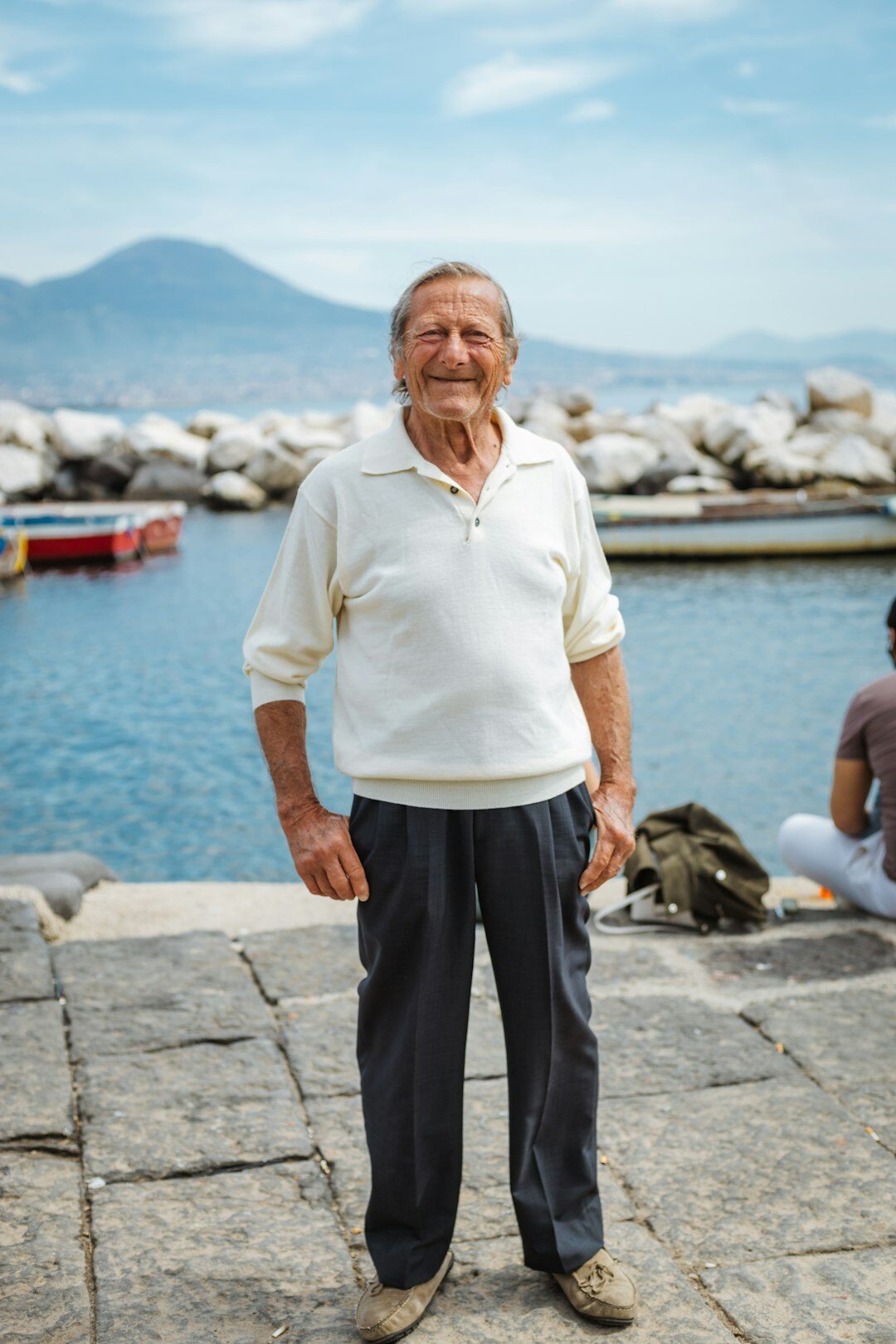 elderly men hugging by harbor