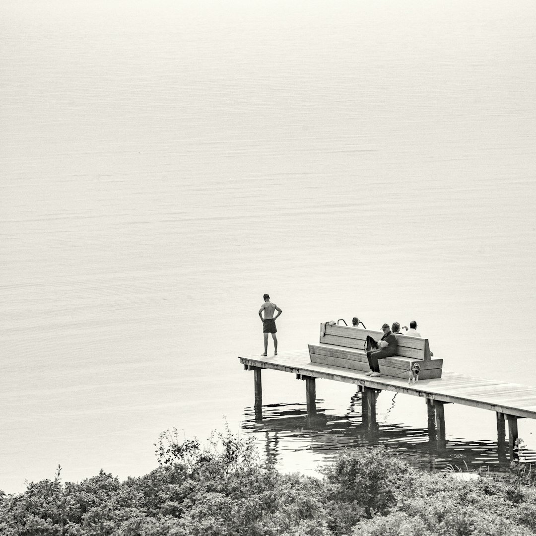 Fishermen mending nets on a wooden pier in a Danish fishing village